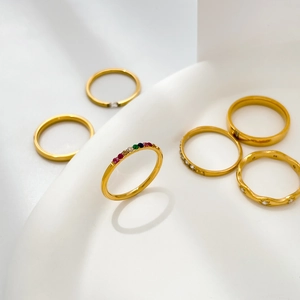 Collection of slim gold rings featuring multi-color rainbow stones and cubic zirconia