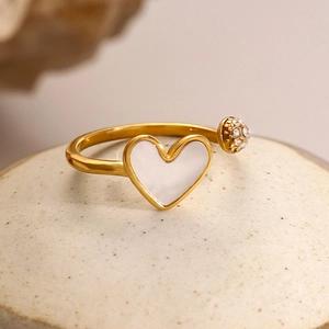 Detailed macro view of 18k gold plated stainless steel open ring with shell heart and zircon