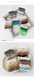 Detail view of colorful satin scrunchies set in earthy and morandi tones on a card