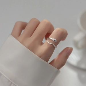 Macro shot of an adjustable silver snake ring with metallic luster on finger