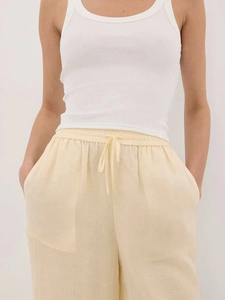 Detail showing high-waisted linen-blend wide-leg trousers with drawstring and elastic waist