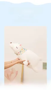 Close-up of white polar bear plush toy featuring soft fur and floral scarf detail