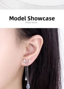 Detail of silver butterfly tassel earrings with moonlight stones on a model