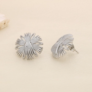 Macro shot of silver geometric flower stud earrings made of high-quality titanium steel