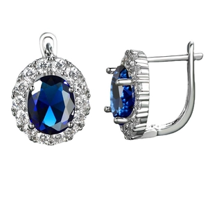 Elegant silver oval hoop earrings with a large blue zircon and white crystal border