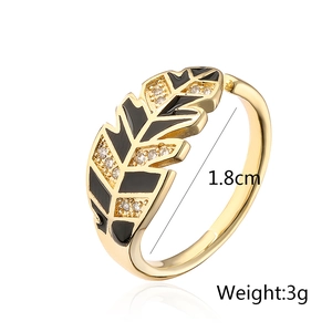Detailed view of gold-plated leaf ring with black enamel and micro-pave zircons