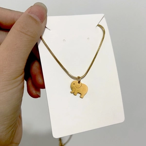 Detail of 18K gold elephant pendant on a sleek snake bone chain necklace for women