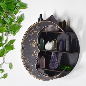 Boho round wooden moon shelf with crystals and plants hanging on a wall for decor