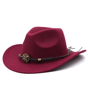 Close-up of wine red felt cowboy hat featuring ethnic braided rope and metal ornament