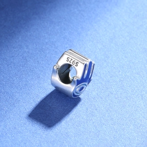 Detailed macro view of S925 sterling silver bead with blue enamel evil eye charm