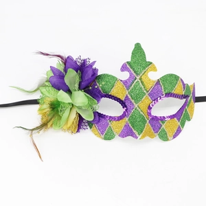 Detailed view of Mardi Gras mask with purple feathers, gold glitter and sequins