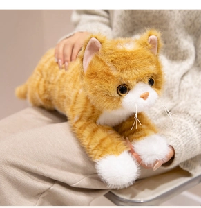 Detailed view of the soft orange tabby cat plush toy with realistic fur and whiskers