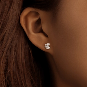 Macro view of S925 sterling silver fish-shaped stud earrings with marquise-cut zircons