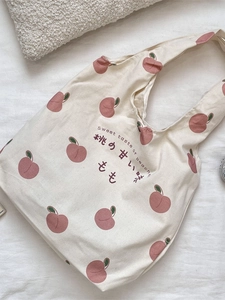 Minimalist canvas tote bag with peach prints and Sweet Taste text on white fabric