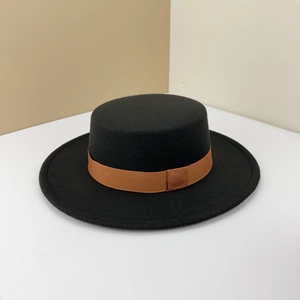 Classic black wool boater hat with a brown grosgrain ribbon band shown from a side view