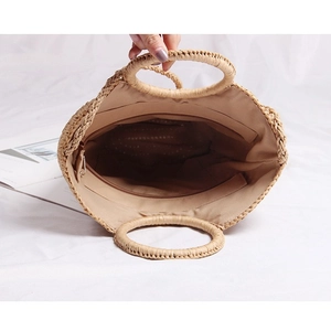 Straw shoulder bag with round handles and spacious interior for beach vacations
