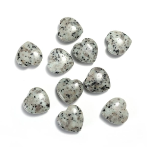 Detailed view of nine heart-shaped natural gemstones with granite patterns on white background