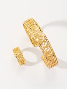 Detail of gold-plated open bangle and ring set featuring intricate hollow-out patterns