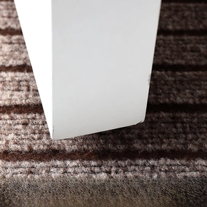 Detailed view of brown striped doormat thickness designed for low door clearance