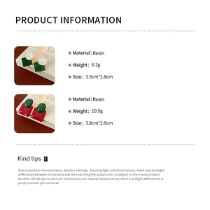 Detailed view of geometric resin earrings showing green square and red rectangle elements