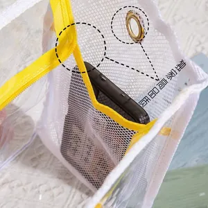 Detail view of transparent PVC mesh beach bag with yellow zipper and metal eyelet