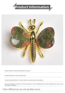 Macro detail of unakite crystal butterfly ornament with heart-shaped wings and golden body