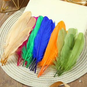 Colorful DIY goose feathers in mixed shades on a woven mat for craft decorations