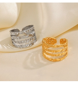 Macro detail of layered hammer texture on gold and silver adjustable open rings