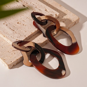 Exaggerated contrast resin chain earrings with tortoiseshell texture and geometric links