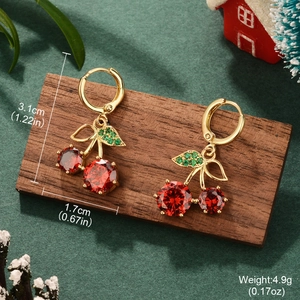 Macro detail of cherry earrings with dimensions 3.1x1.7cm and weight 4.9g in holiday theme