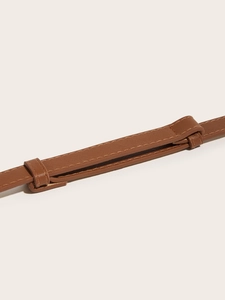 Detail shot of brown crossgrain leather belt texture with precision stitching quality