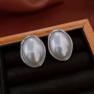 French vintage oval pearl earrings with silver metal frame in a luxury wooden gift box