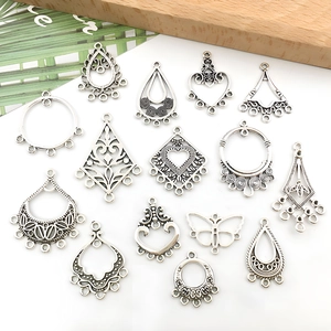 Detail view of vintage alloy earring connectors in heart and teardrop shapes