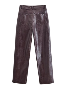 Detail view of deep brown crocodile texture faux leather trousers with two back pockets