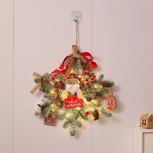 Close-up of Christmas wreath with Santa doll, LED lights and Feliz Navidad wooden sign