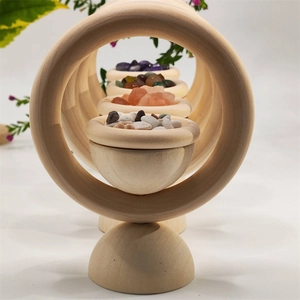 Close-up of a large wooden ring holder featuring small bowls filled with colorful crystals
