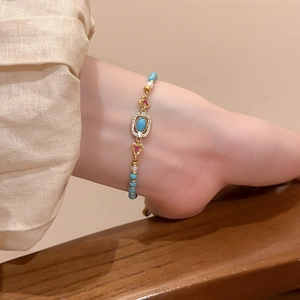 Detailed close-up of a vintage-style bracelet with turquoise beads and small pearls
