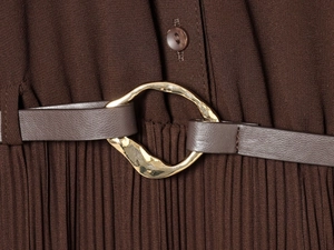 Close-up of pleated midi dress with brown leather belt and gold irregular buckle
