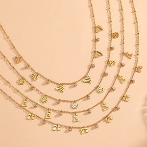 Detail view of 18K gold plated necklaces featuring hollow heart and cherry pendants