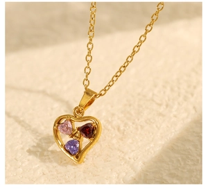 Close-up of gold plated heart necklace featuring colorful inlaid zircon heart stones