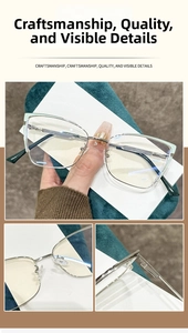 Macro detail of cat-eye metal glasses frame featuring silver hinges and green accents