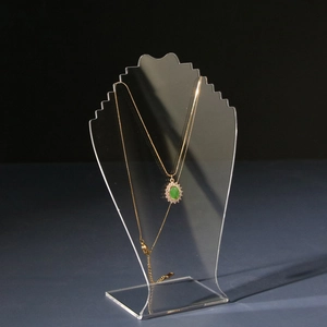 Transparent acrylic necklace display stand with jagged hooks shown from a 45-degree angle