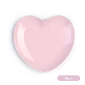 Detailed view of pink heart-shaped stainless steel tray with polished smooth finish