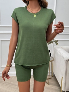 Women's green ribbed knit two-piece set with round neck short sleeve top and matching shorts