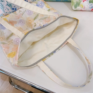 Détail de la fermeture éclair métallique et de la doublure intérieure du sac cabas à fleurs