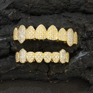 Exaggerated golden hip-hop grillz with eight teeth design and pavé set cubic zirconia