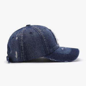 Deep blue washed denim baseball cap with distressed details and metal buckle