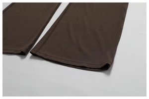 Macro shot of double-needle stitching on the hem of brown quick-dry flare yoga pants