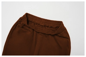 Close-up of elastic waistband on dark brown wide-leg jogger pants with durable stitching