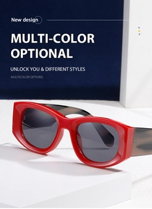 Close-up of red square frame sunglasses with tortoiseshell temples on white props
